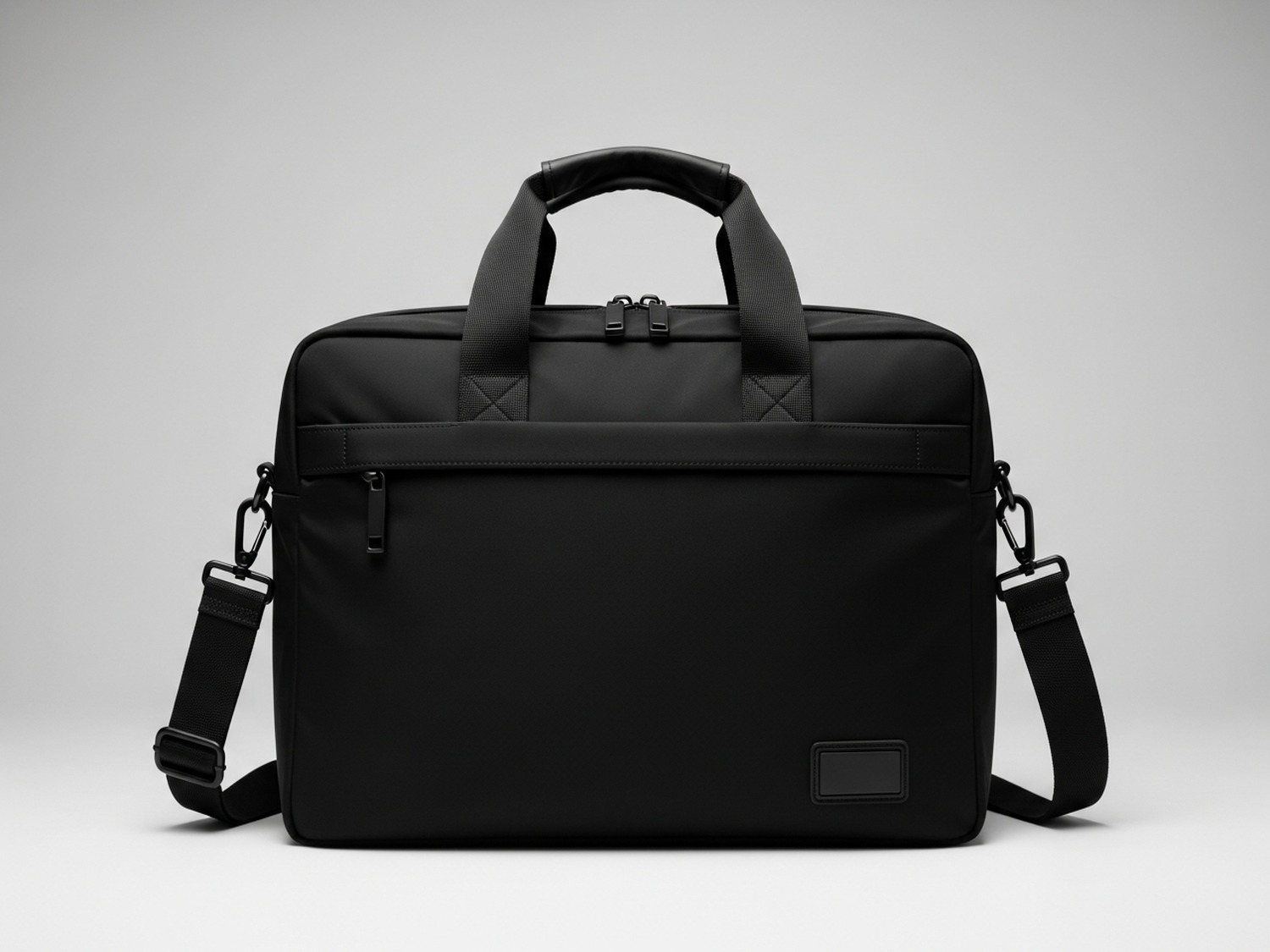 The same black executive travel bag on a clean white studio sweep, soft diffused light, natural contact shadow — catalog-ready product shot.
